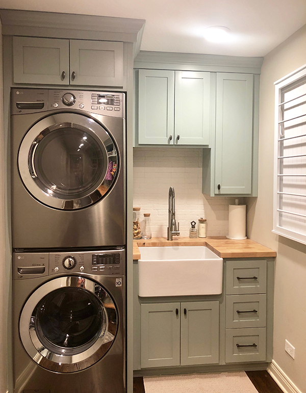 Laundry Room with Stainless Steel Appliances and Light Green Cabinets