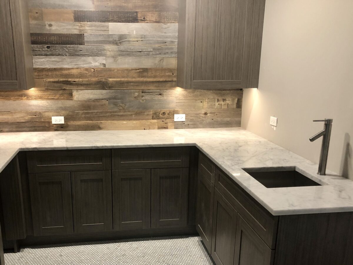 Dark Gray Wet Bar with Sink and Rustic Wood Wall