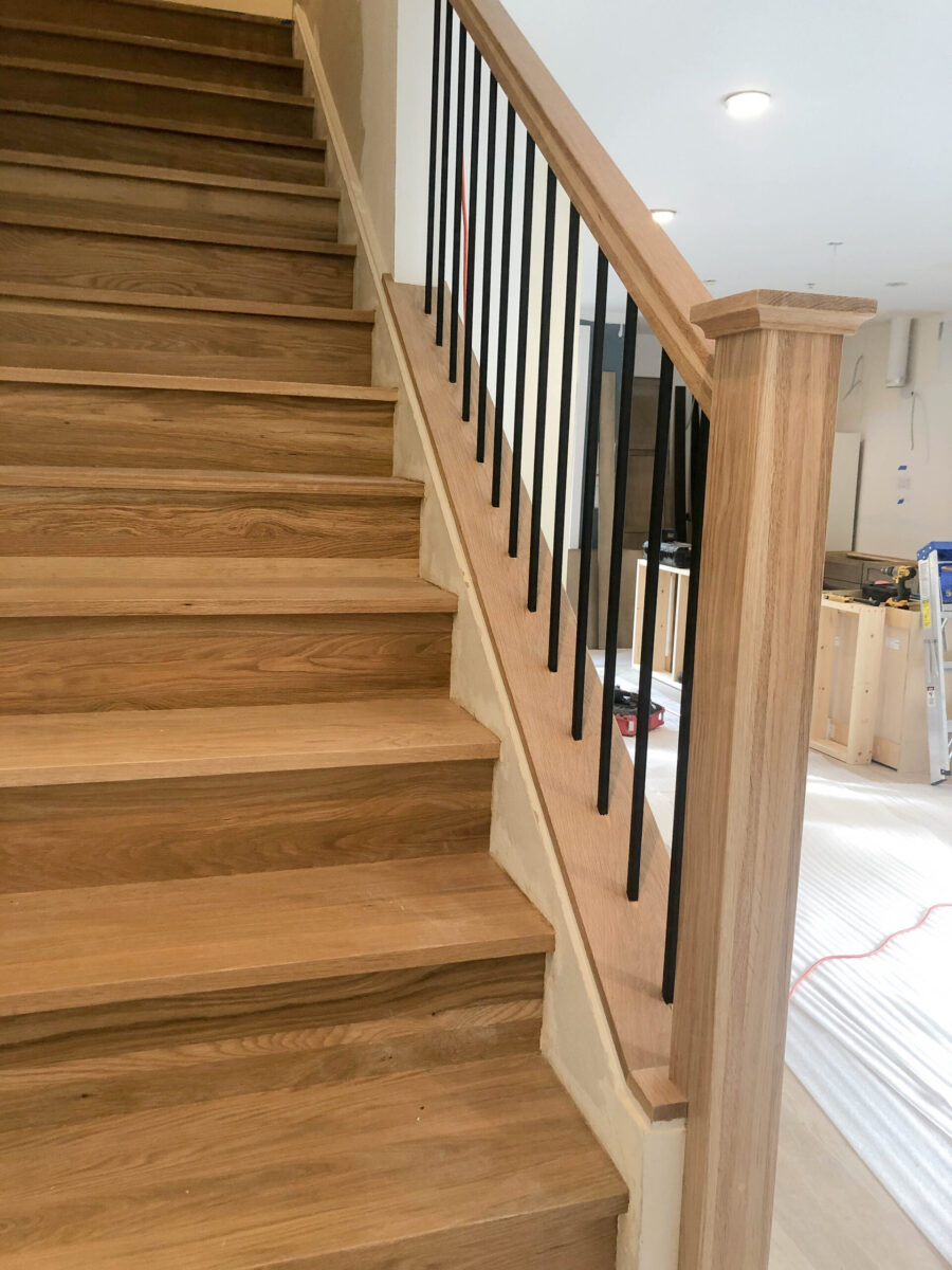 Warm Wood Basement Stairs with Black Spindles