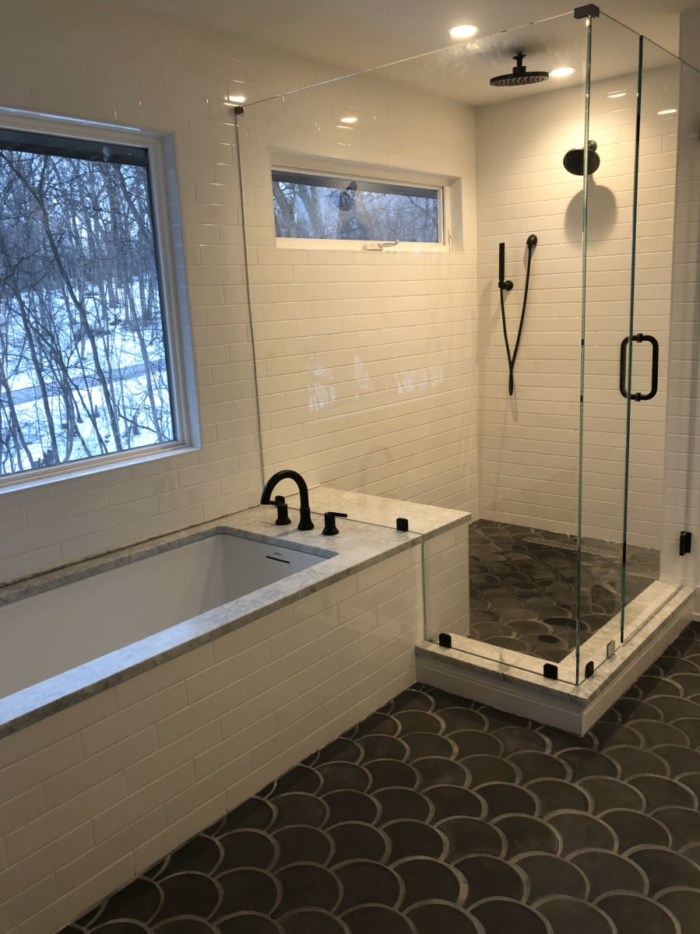 Simple Bathtub and Glass Shower with White Tile and Black Hardware