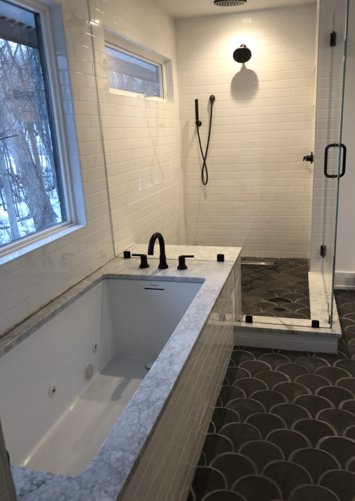 Simple Bathtub and Glass Shower with White Tile and Black Hardware