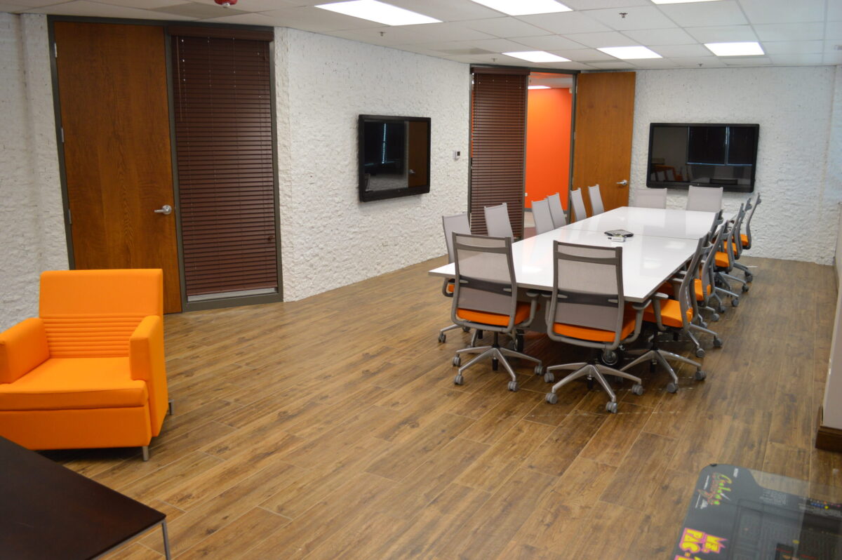 Commercial Conference Room with Wooden Floors and Stone Walls