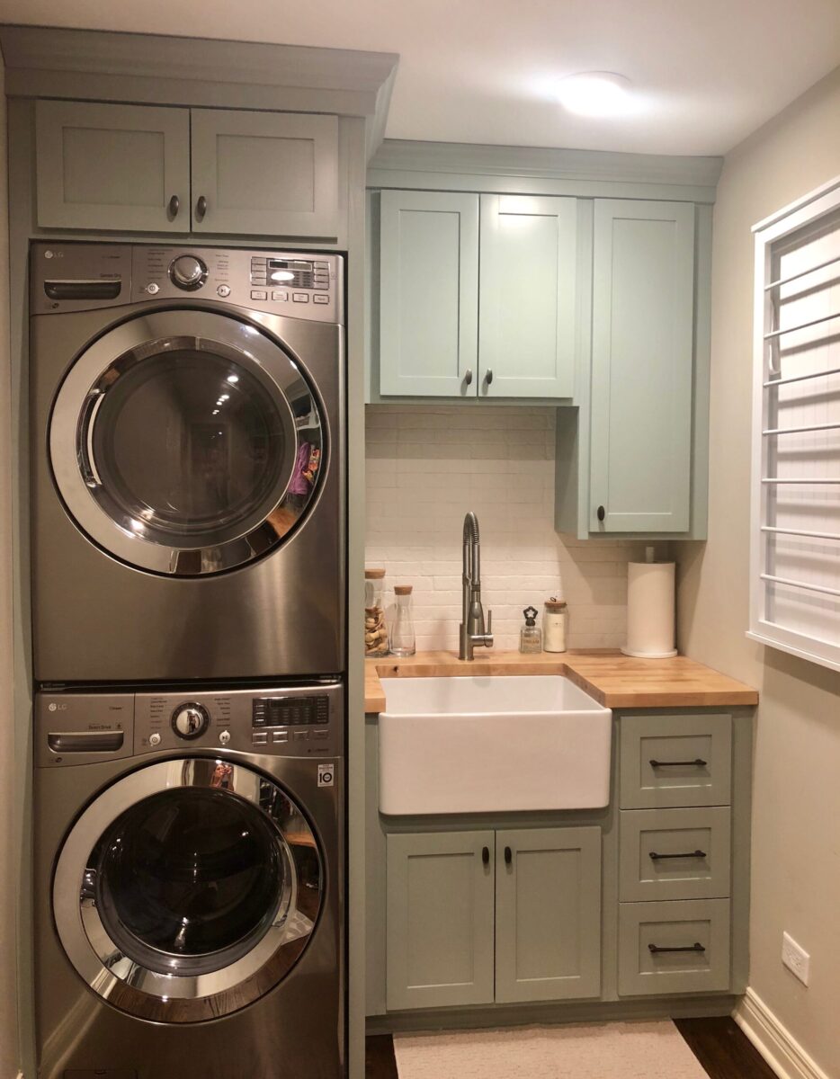Laundry Room with Stainless Steel Appliances and Light Green Cabinets