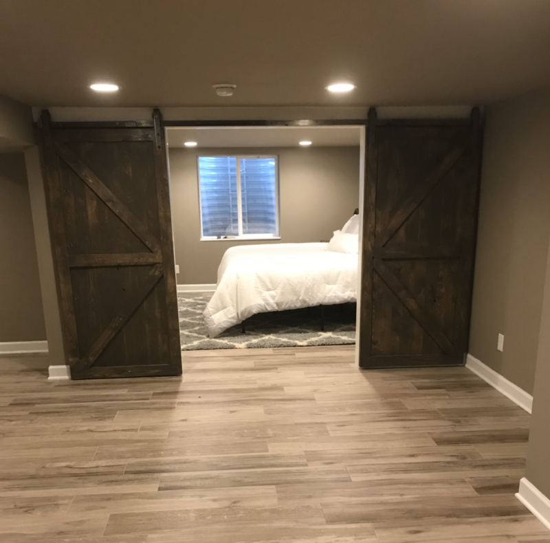 Bedroom with Barn Wood Door and Rustic Interior Finishes