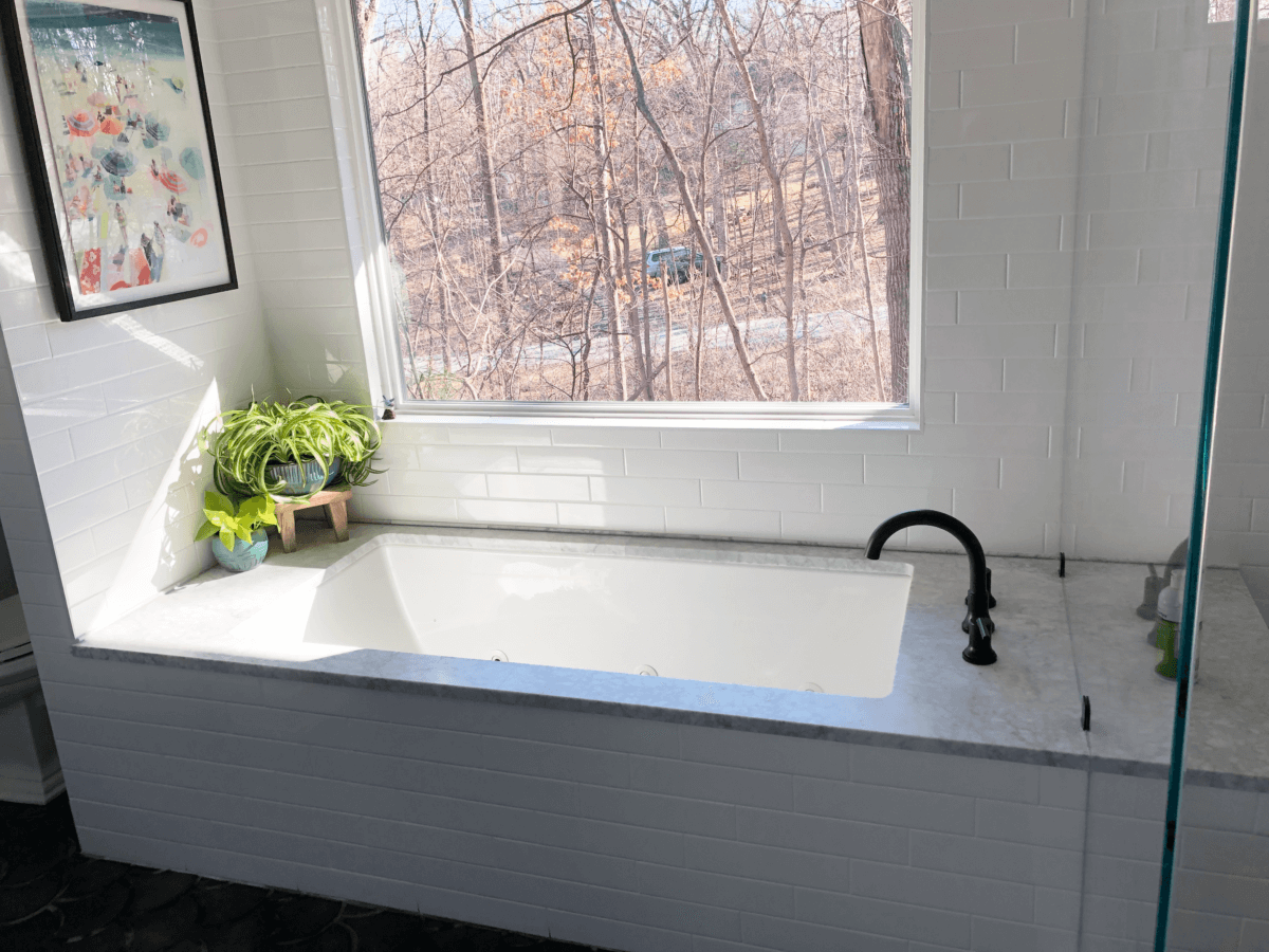 Simple Bathtub with White Tile and Black Hardware